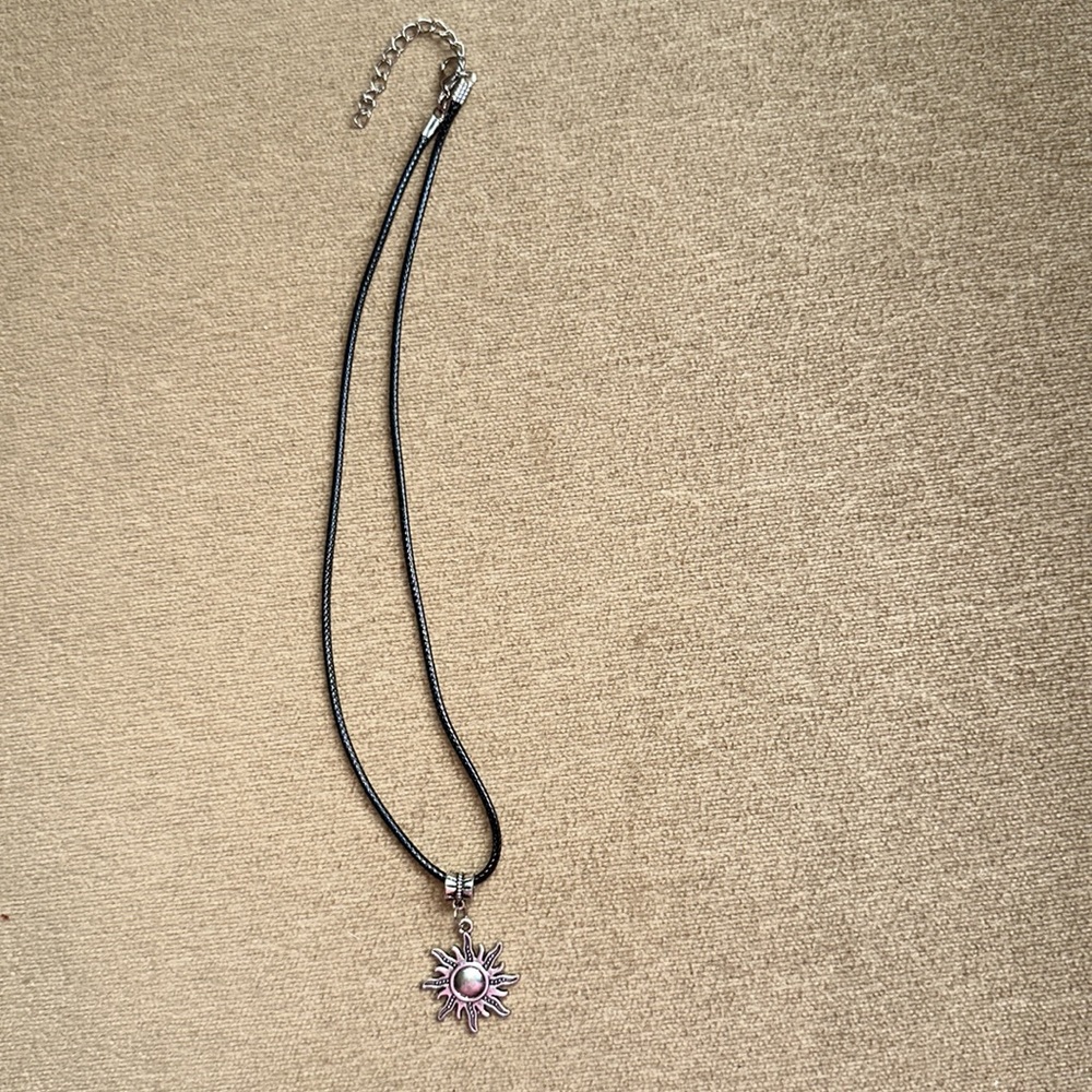 Black cord choker with sun charm